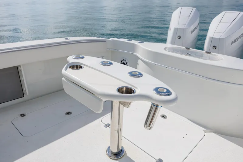 Slide: The Image of 2014 Yellowfin 42 Offshore boat deck with rod holders and twin Mercury engines. - 18