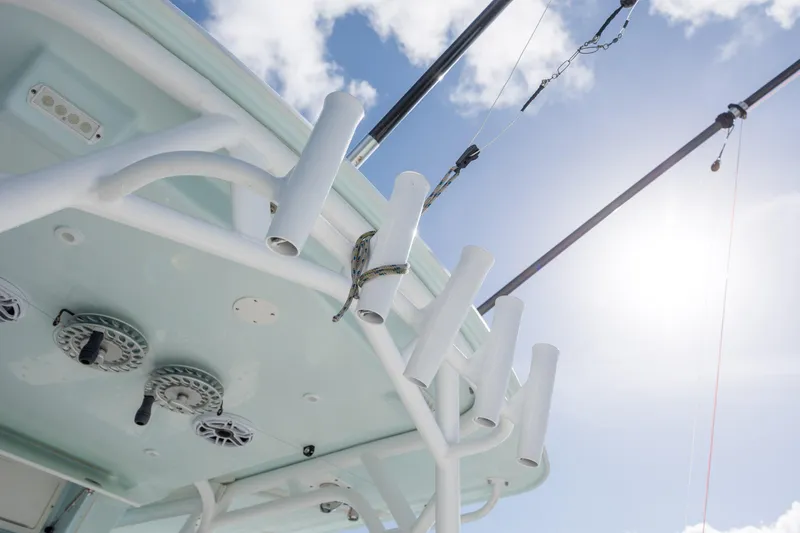 Slide: The Image of 2014 Yellowfin 42 Offshore boat with rod holders and reels under sunny sky. - 22