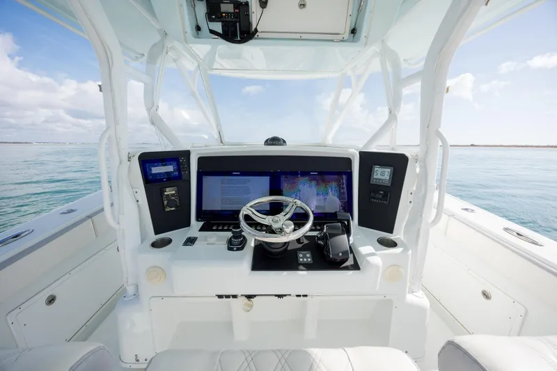 Slide: The Image of 2014 Yellowfin 42 Offshore boat helm with advanced navigation system and ocean view. - 24