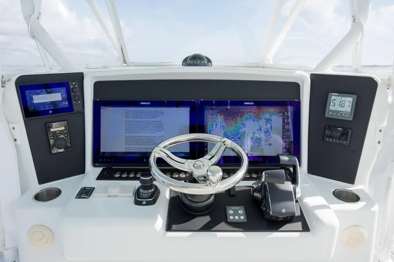 Slide: The Image of Control panel of 2014 Yellowfin 42 Offshore boat with advanced navigation displays. - 25