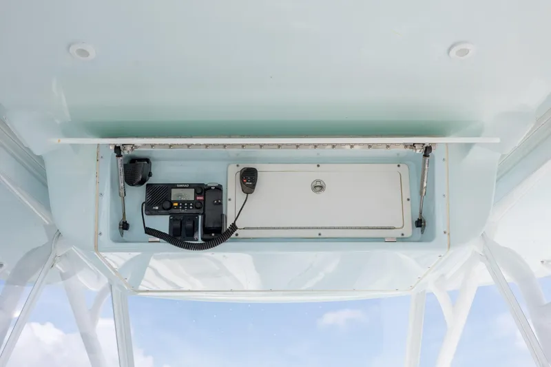 Slide: The Image of 2014 Yellowfin 42 Offshore boat console with radio equipment and storage compartment. - 26