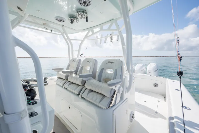 Slide: The Image of 2014 Yellowfin 42 Offshore boat interior with luxurious seating and ocean view. - 27