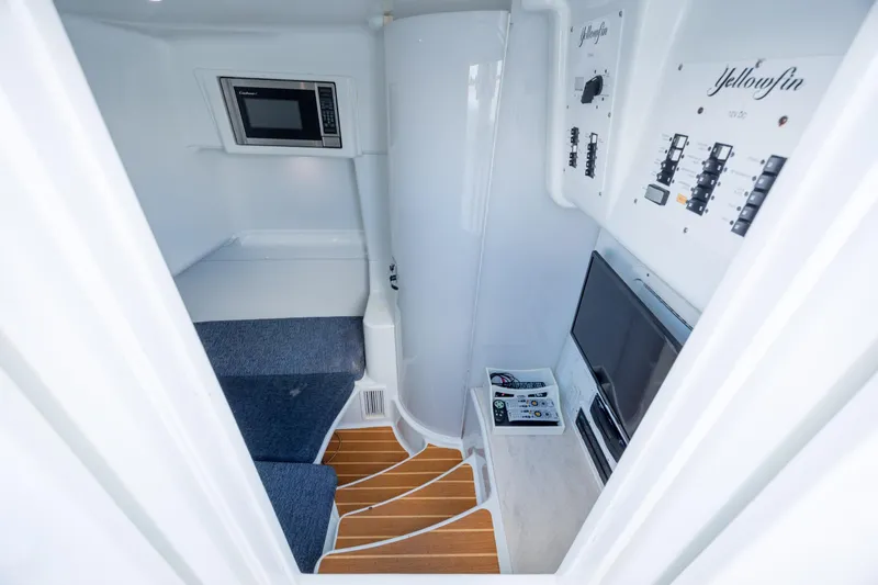 Slide: The Image of Interior of 2014 Yellowfin 42 Offshore boat with seating, microwave, and control panels. - 37