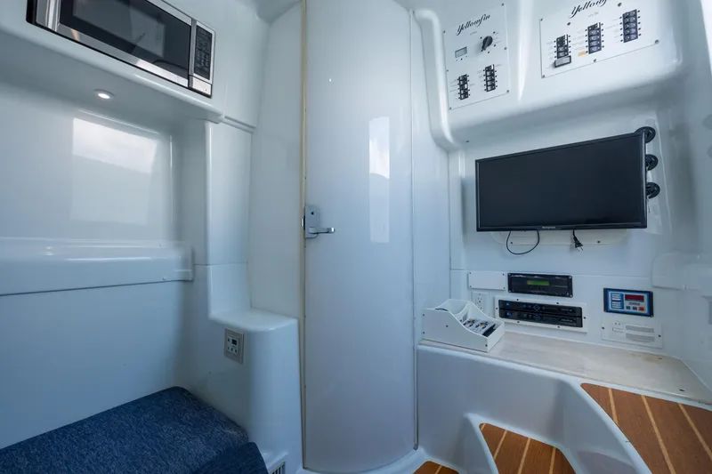 Slide: The Image of 2014 Yellowfin 42 Offshore cabin with microwave, TV, and control panels. - 40
