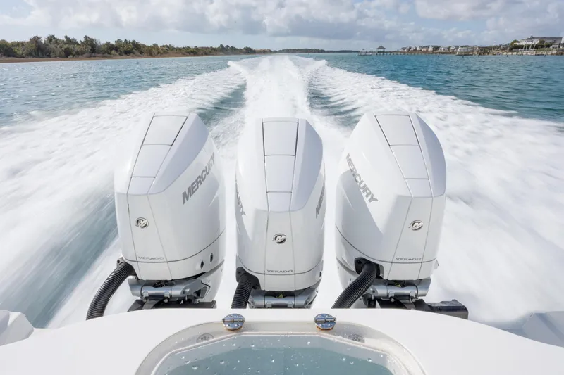 Slide: The Image of 2014 Yellowfin 42 Offshore boat with triple Mercury Verado engines cruising on water. - 43