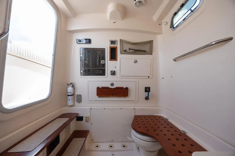 Slide: The Image of 2013 Grady-White Canyon 306 boat interior with control panel and seating area. - 13