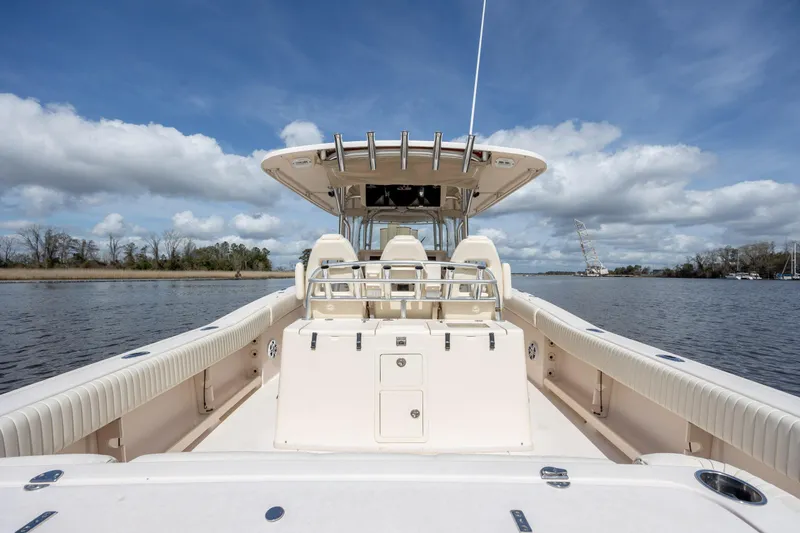 Slide: The Image of 2013 Grady-White Canyon 306 boat on calm water under a blue sky. - 18