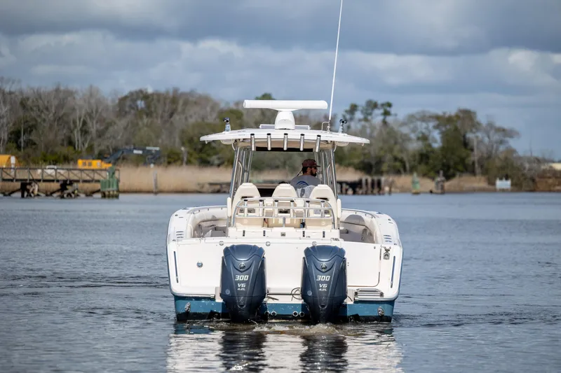 Slide: The Image of 2013 Grady-White Canyon 306 boat with dual engines on a calm waterway. - 2