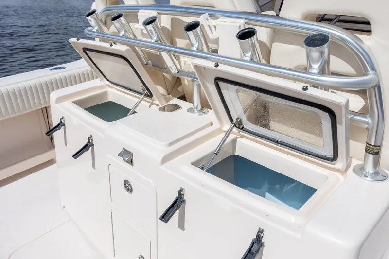 Slide: The Image of 2013 Grady-White Canyon 306 boat with open storage compartments and rod holders. - 20