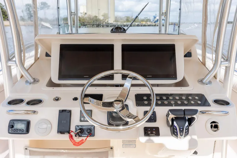 Slide: The Image of 2013 Grady-White Canyon 306 helm with dual screens and modern controls. - 22