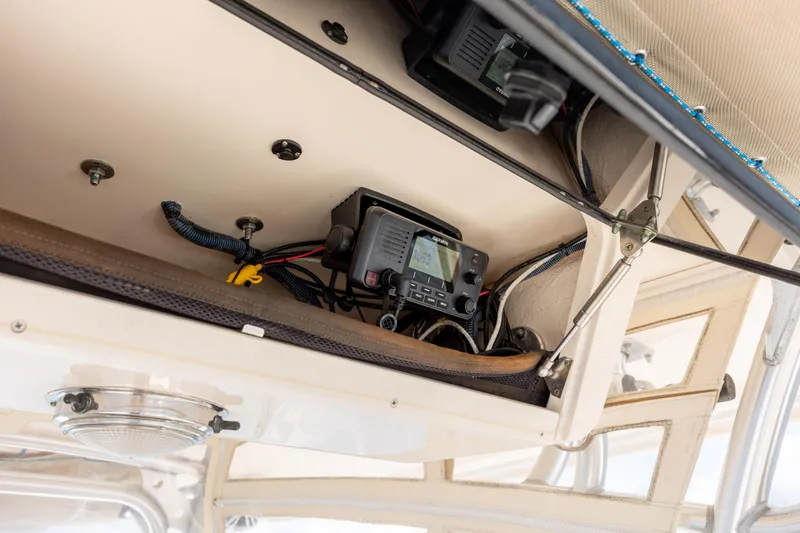 Slide: The Image of 2013 Grady-White Canyon 306 boat electronics compartment with Garmin device and wiring. - 26