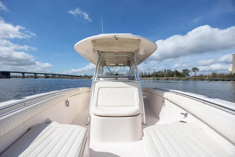 Slide: The Image of 2013 Grady-White Canyon 306 boat on calm water under blue sky. - 29