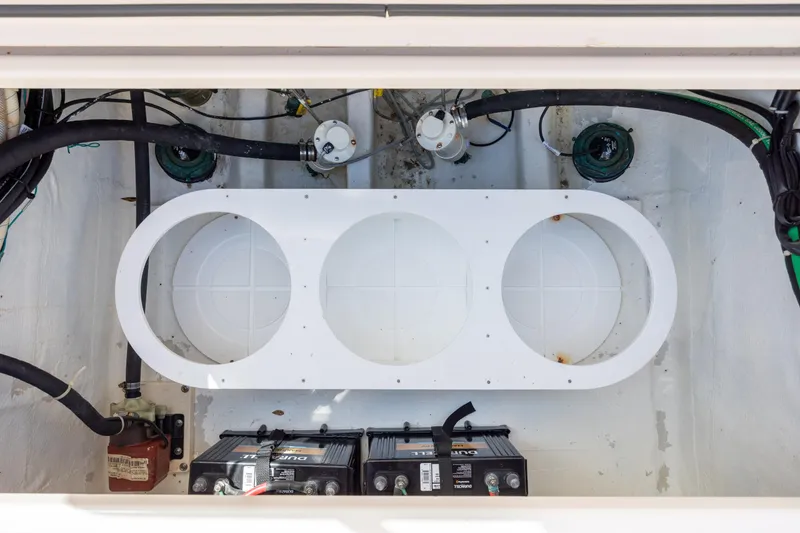 Slide: The Image of 2013 Grady-White Canyon 306 boat battery compartment with wiring and components. - 31