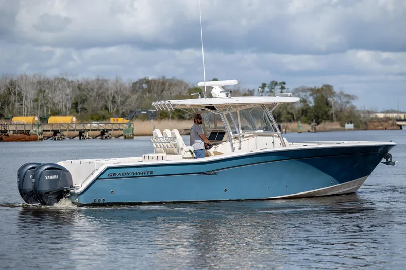 Slide: The Image of 2013 Grady-White Canyon 306 boat cruising on a calm river with Yamaha engines. - 32