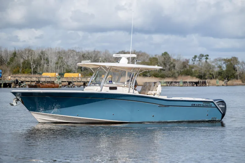 Slide: The Image of 2013 Grady-White Canyon 306 boat on calm water, side view. - 34