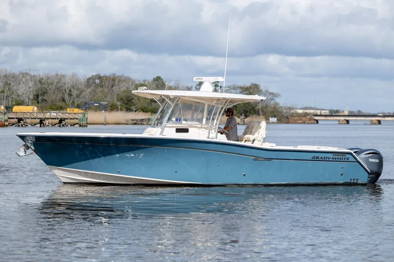 Slide: The Image of 2013 Grady-White Canyon 306 boat on calm water, side view. - 5