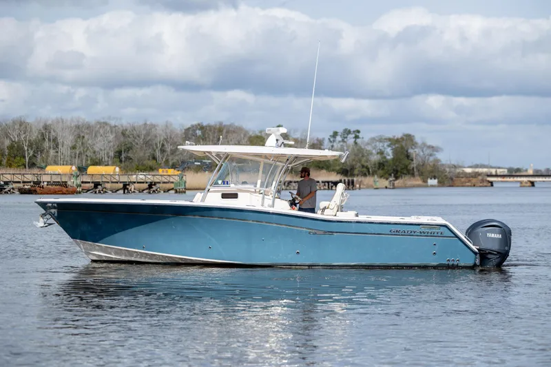 Slide: The Image of 2013 Grady-White Canyon 306 boat on calm water with Yamaha engines. - 6