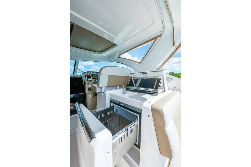 Slide: The Image of 2012 Tiara Yachts 3100 Coronet interior with open storage compartments and seating. - 11