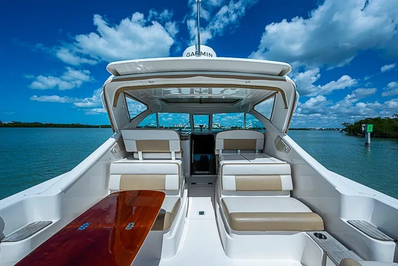 Slide: The Image of 2012 Tiara Yachts 3100 Coronet on water, showcasing spacious seating and sleek design. - 12