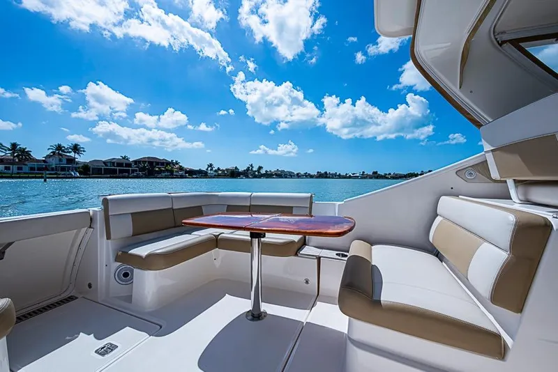 Slide: The Image of Luxurious seating area on a 2012 Tiara Yachts 3100 Coronet, overlooking serene waters. - 15