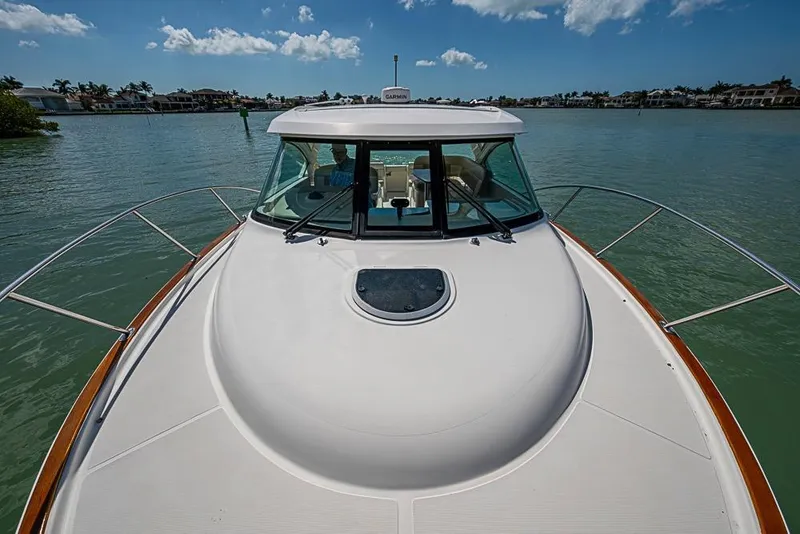 Slide: The Image of 2012 Tiara Yachts 3100 Coronet cruising on calm waters under a clear blue sky. - 18