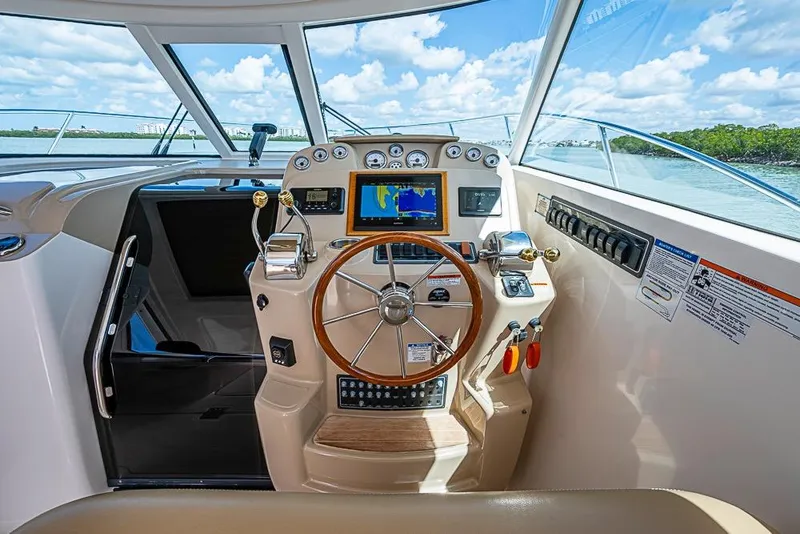 Slide: The Image of 2012 Tiara Yachts 3100 Coronet helm with navigation system and steering wheel. - 6