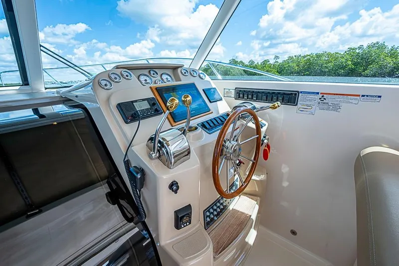 Slide: The Image of Helm of 2012 Tiara Yachts 3100 Coronet with steering wheel and control panel. - 7