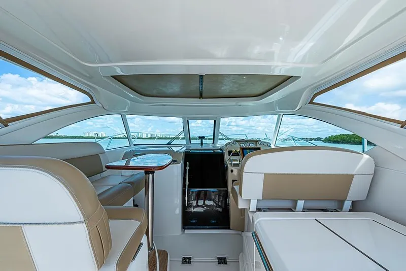 Slide: The Image of Interior view of 2012 Tiara Yachts 3100 Coronet, featuring luxurious seating and helm. - 9
