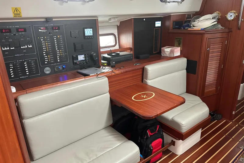 Slide: The Image of 2023 Island Packet 439 yacht interior with navigation panel and seating area. - 2