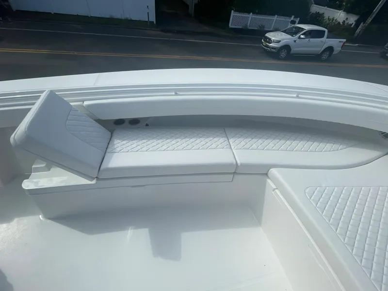 Slide: The Image of 2024 Regulator 34 boat with luxurious white seating area. - 14