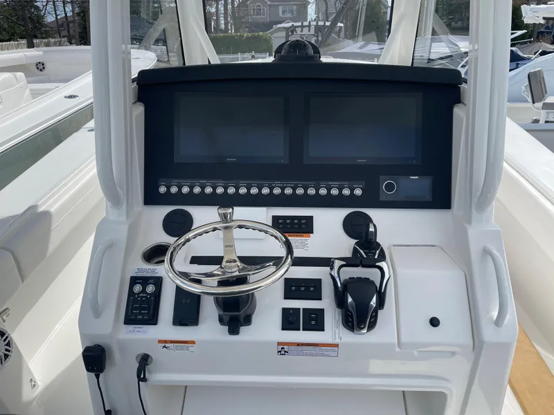 Slide: The Image of 2024 Regulator 34 boat helm with modern controls and dual screens. - 31