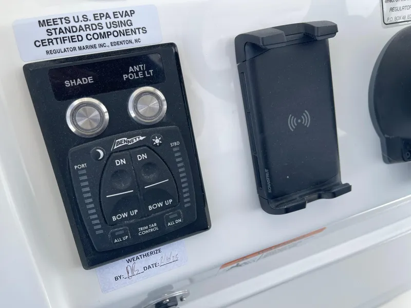 Slide: The Image of Regulator 34 boat controls with trim tabs and charger, year 2024. - 36