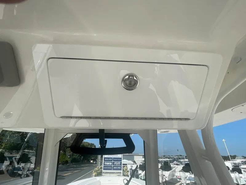 Slide: The Image of Regulator 34 2024 boat, deck view with storage compartment. - 38