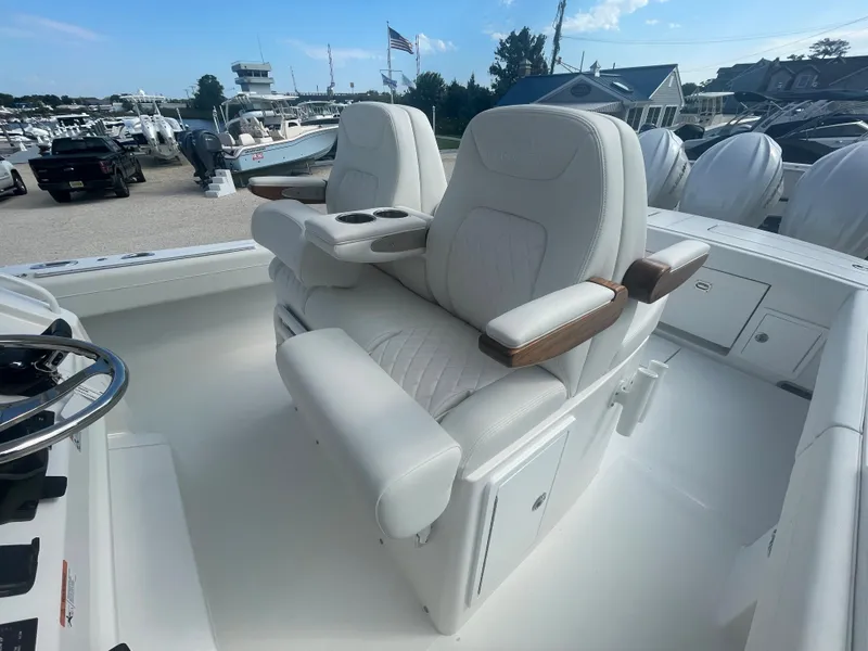 Slide: The Image of Luxurious seating in 2024 Regulator 34 boat, marina background. - 40
