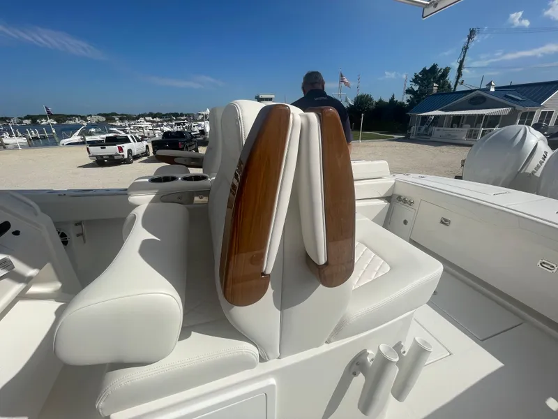 Slide: The Image of 2024 Regulator 34 boat with luxurious white seating at the marina. - 42