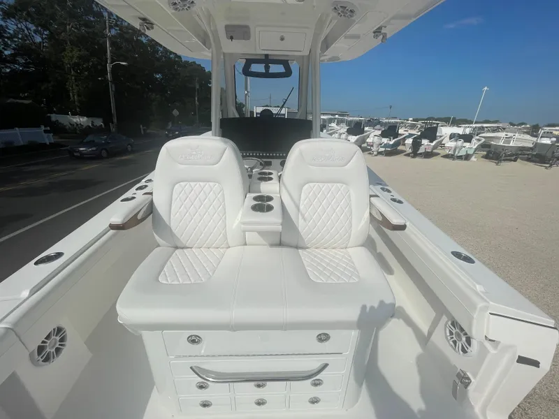 Slide: The Image of 2024 Regulator 34 boat with luxurious white seating outdoors. - 45