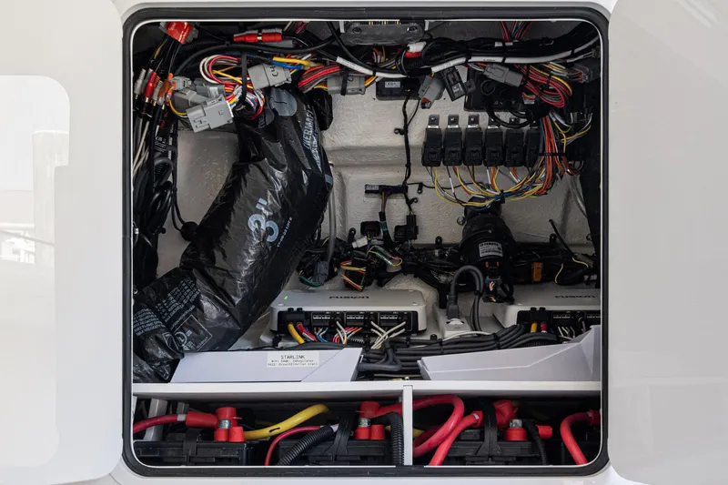 Slide: The Image of 2024 Regulator 34 boat electrical compartment with wiring and components. - 60