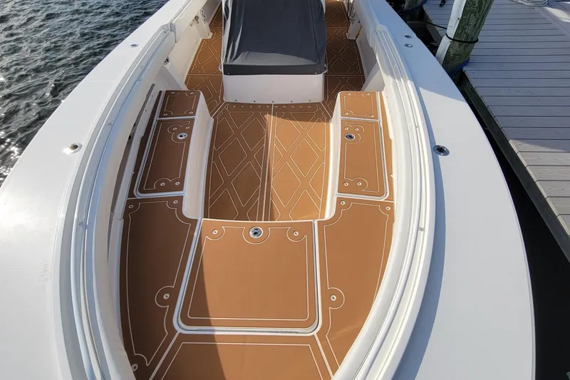 Slide: The Image of 2024 Regulator 34 boat deck with tan and white patterned flooring. - 7