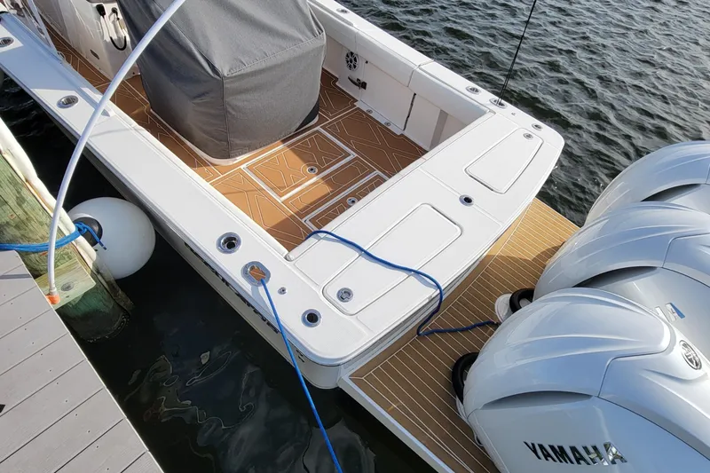 Slide: The Image of 2024 Regulator 34 boat docked, featuring Yamaha engines and sleek deck design. - 8