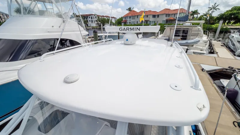 Slide: The Image of 2022 Intrepid 345 Valor boat docked with Garmin radar, surrounded by other vessels. - 10
