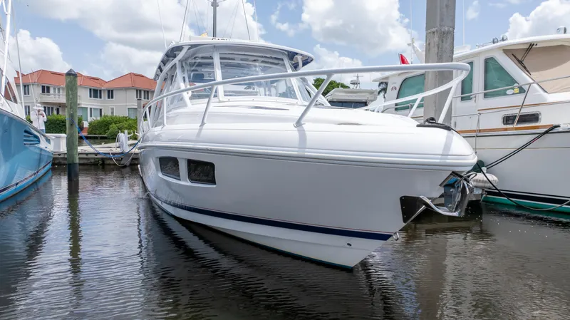 Slide: The Image of 2022 Intrepid 345 Valor boat docked in marina, showcasing sleek design and modern features. - 29