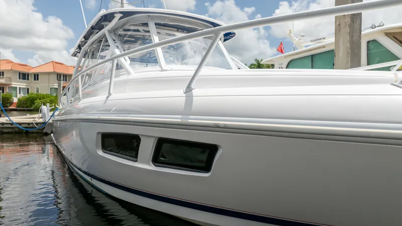 Slide: The Image of 2022 Intrepid 345 Valor boat docked, showcasing sleek design and modern features. - 33