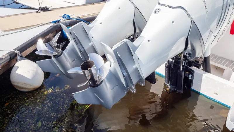 Slide: The Image of Twin outboard motors on a 2022 Intrepid 345 Valor boat, partially submerged in water. - 37