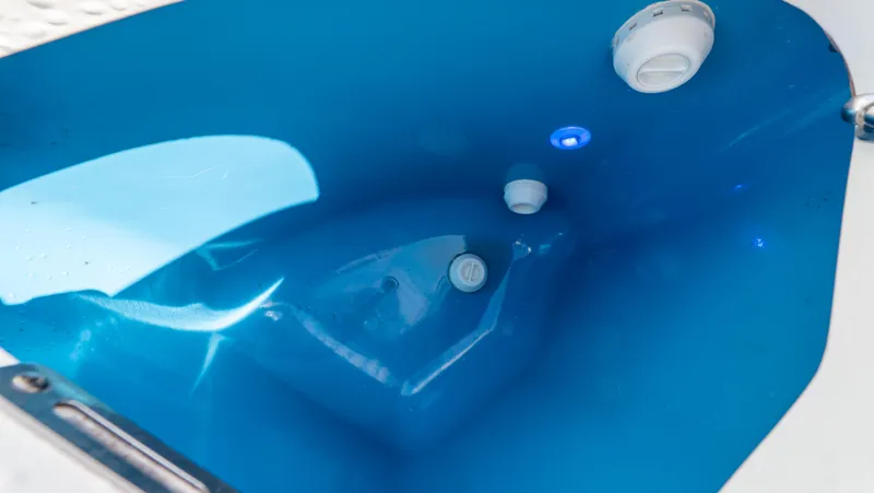 Slide: The Image of 2022 Intrepid 345 Valor boat interior with blue lighting and control features. - 47