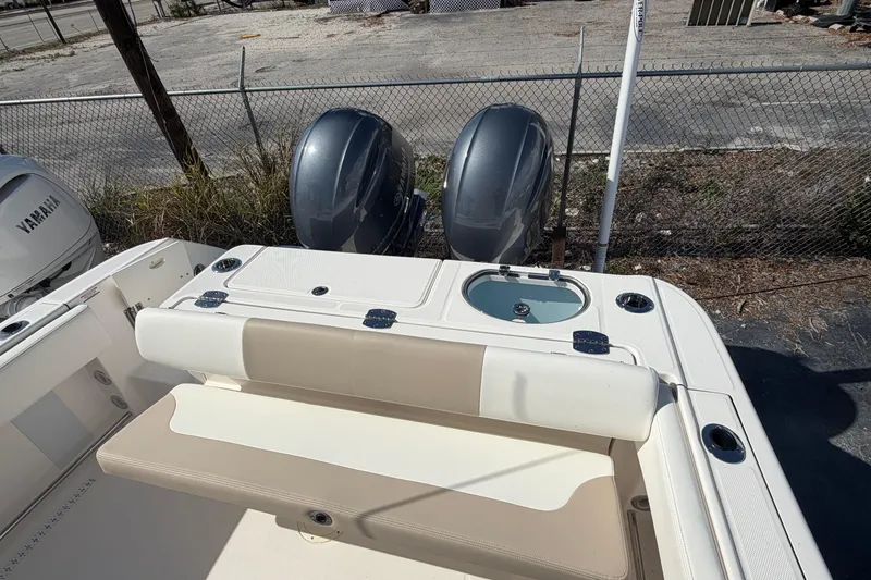 Slide: The Image of 2022 Robalo R242 Center Console boat with dual engines and seating area. - 10