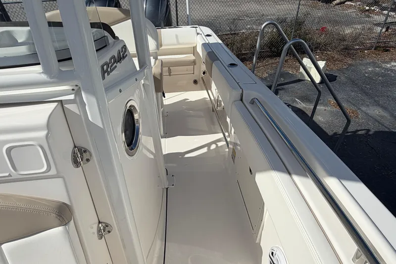 Slide: The Image of 2022 Robalo R242 Center Console boat interior with seating and stainless steel railings. - 13