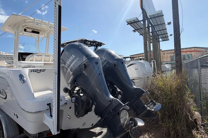 Slide: The Image of 2022 Robalo R242 Center Console boat with dual Yamaha outboard motors. - 3
