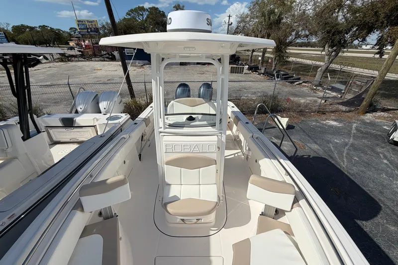 Slide: The Image of 2022 Robalo R242 Center Console boat with dual engines, docked outdoors. - 8