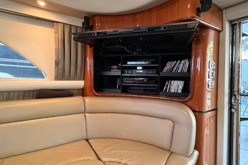 Slide: The Image of Luxurious interior of 2003 Sea Ray 560 Sedan Bridge with entertainment system and leather seating. - 5