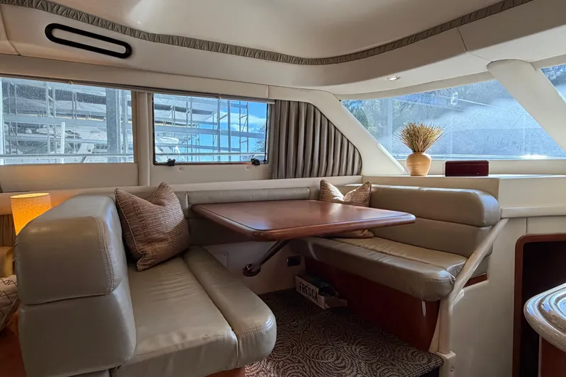 Slide: The Image of Luxurious interior of 2003 Sea Ray 560 Sedan Bridge yacht with elegant seating and table. - 6
